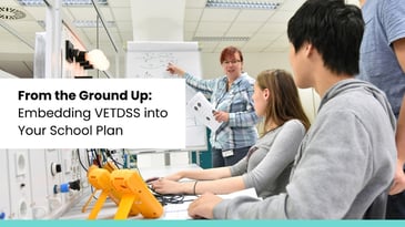 Teacher explaining technical concepts to students in a VETDSS classroom – integrating vocational education into school planning.