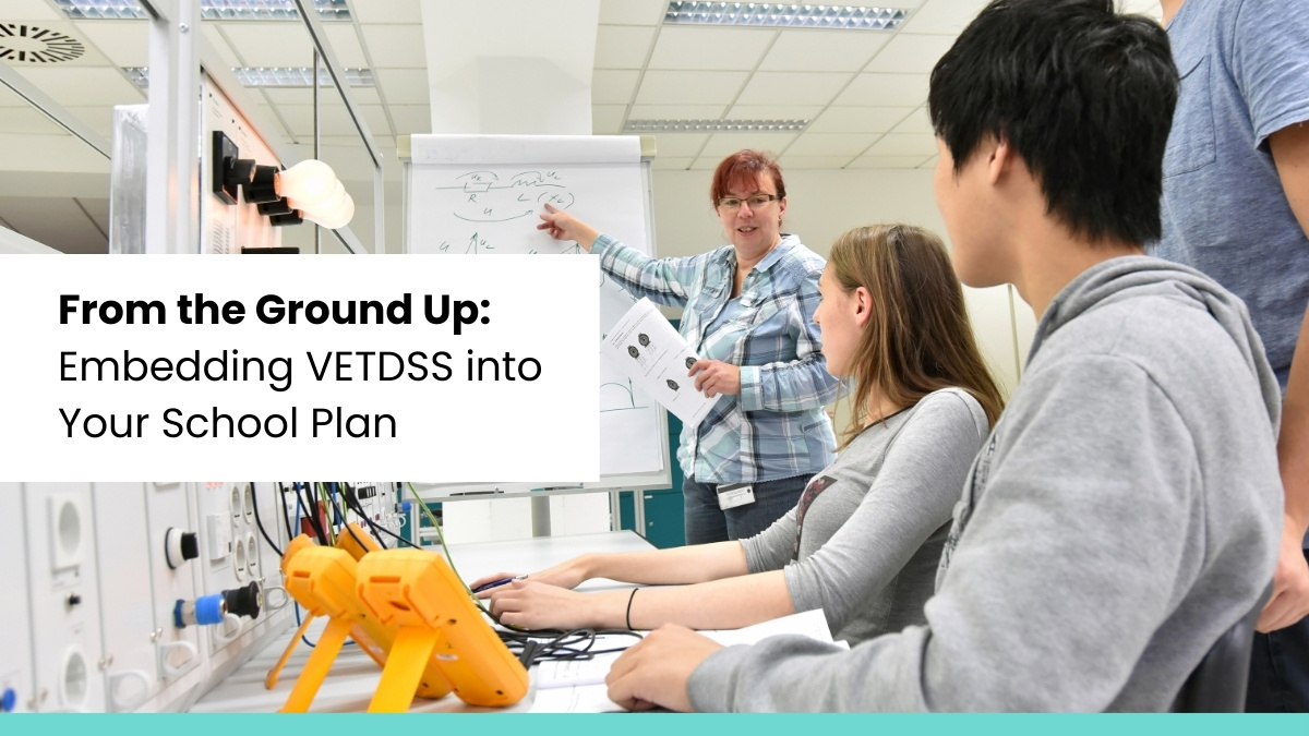 Teacher explaining technical concepts to students in a VETDSS classroom – integrating vocational education into school planning.